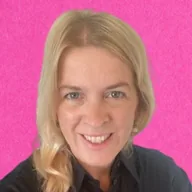 Person with long blonde hair smiling against a bright pink background.